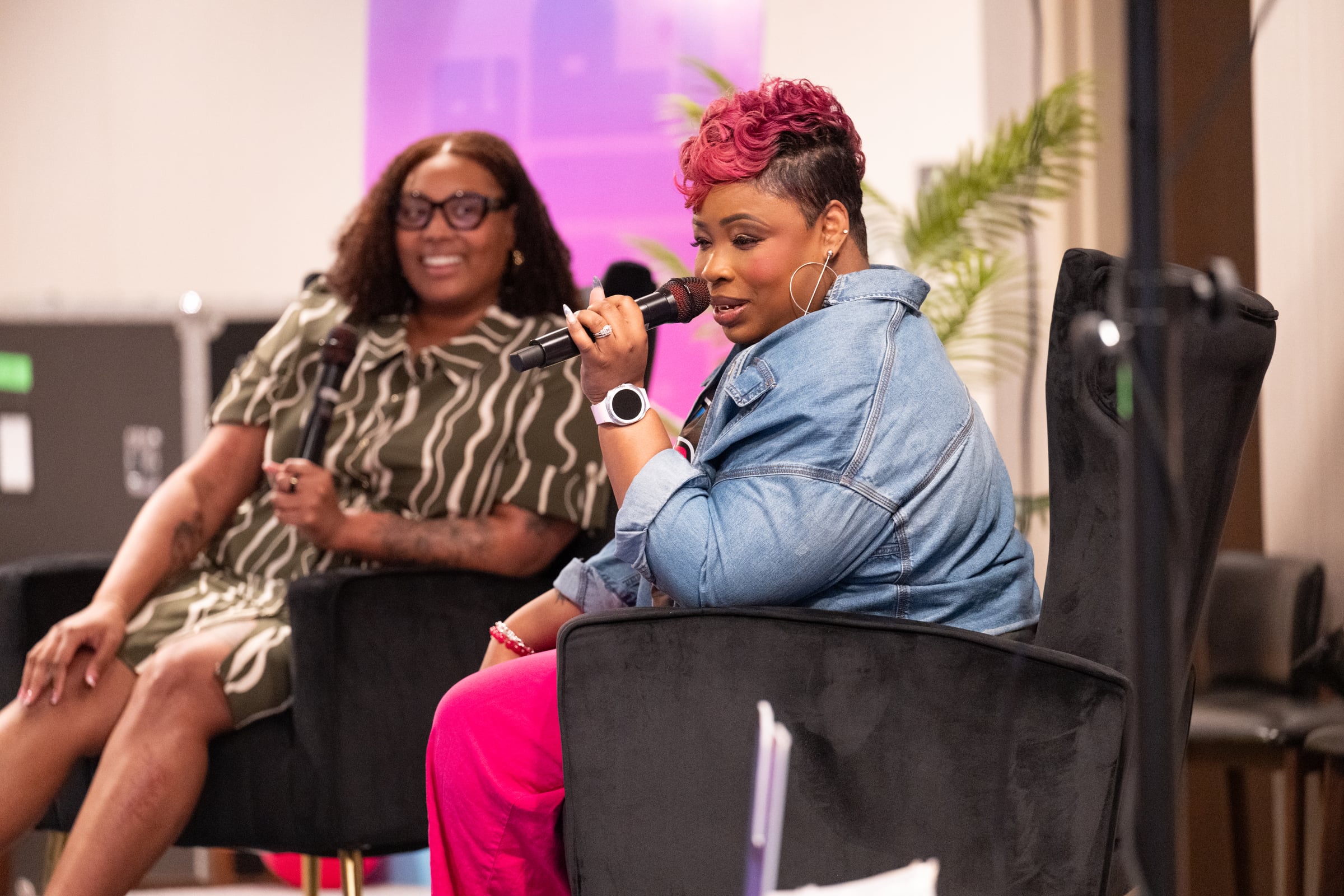 LaShawn Davis speaking on a panel with a microphone