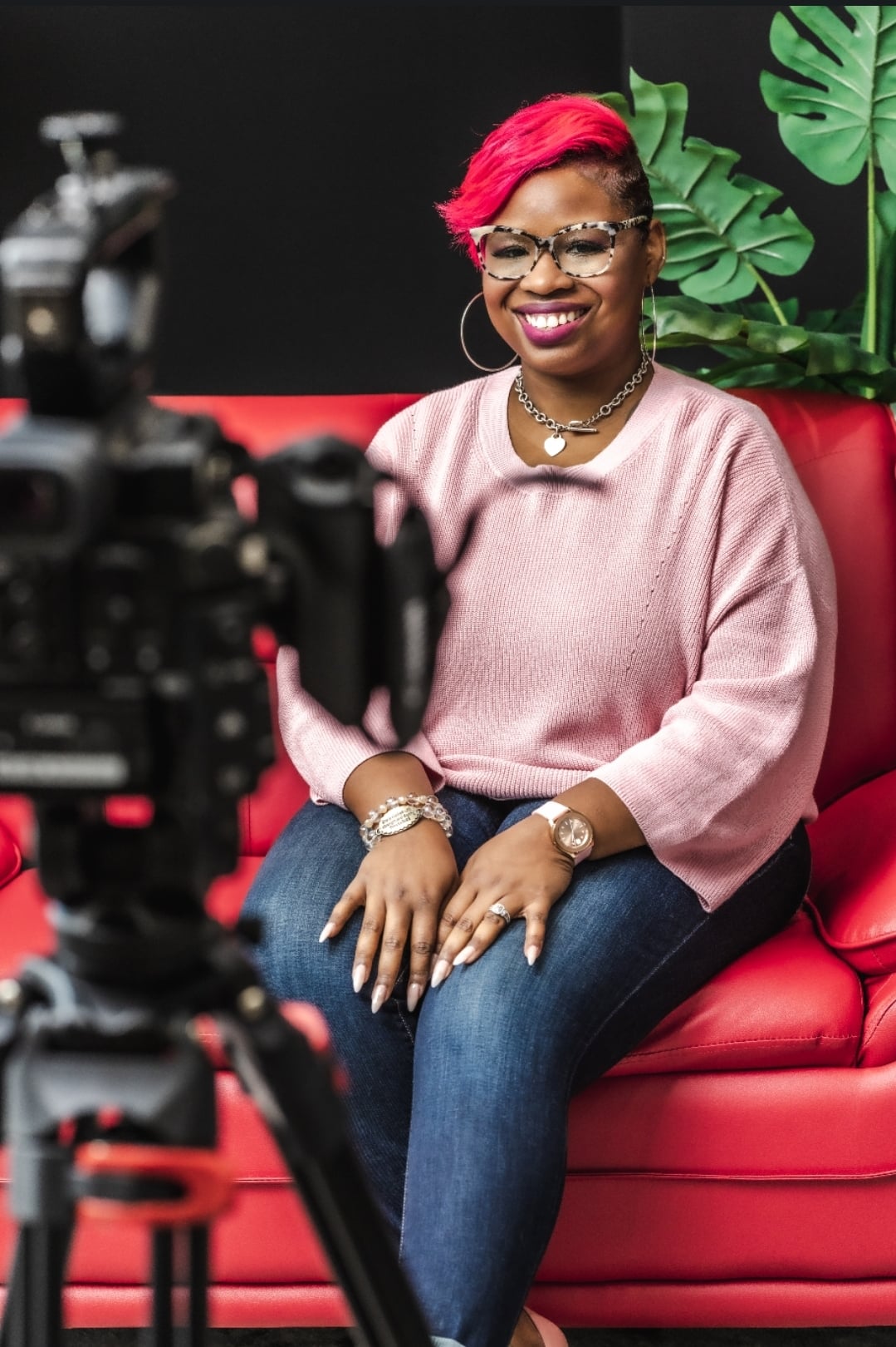 LaShawn Davis filmed while seated on a red couch
