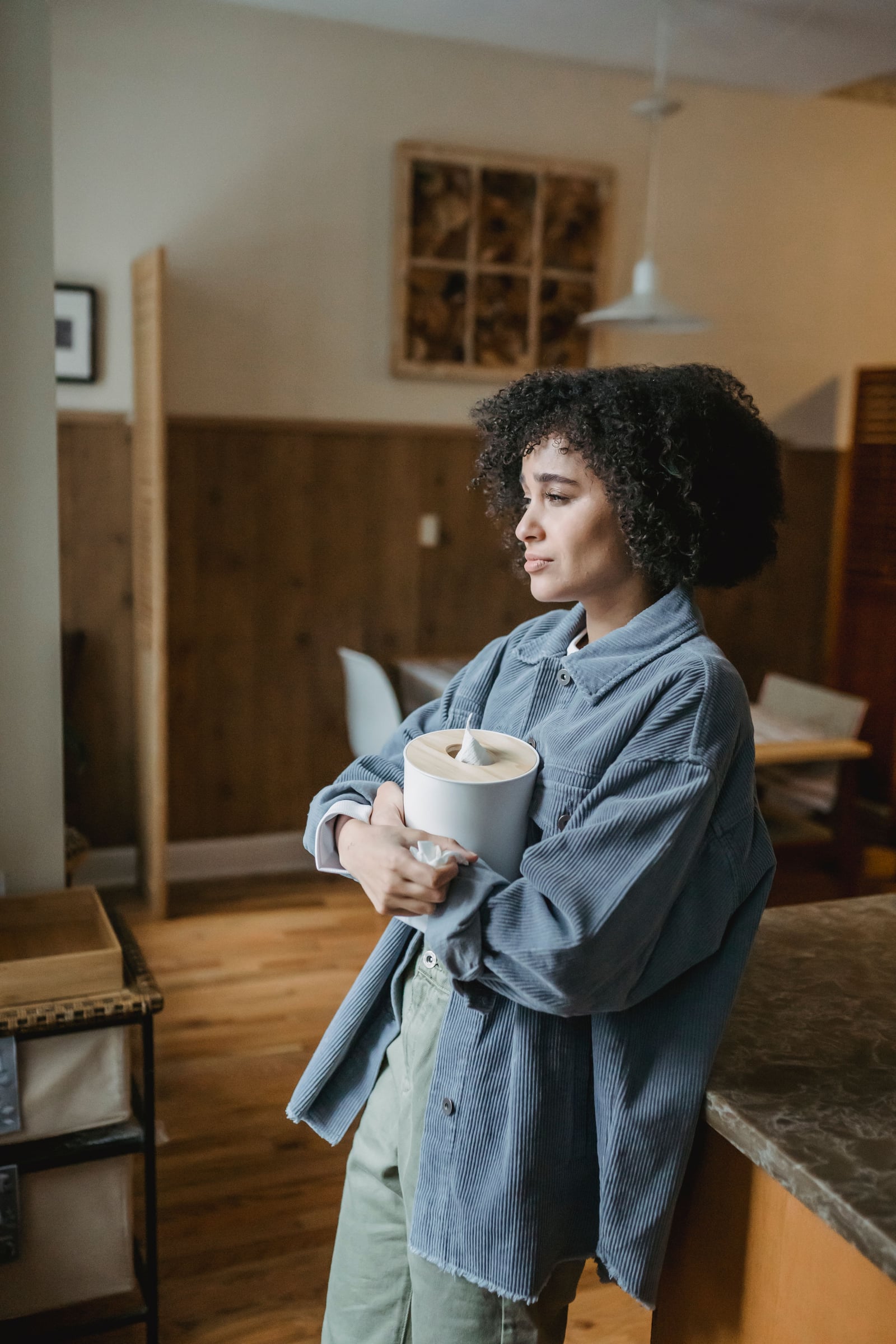 A woman pausing at home, outside of work