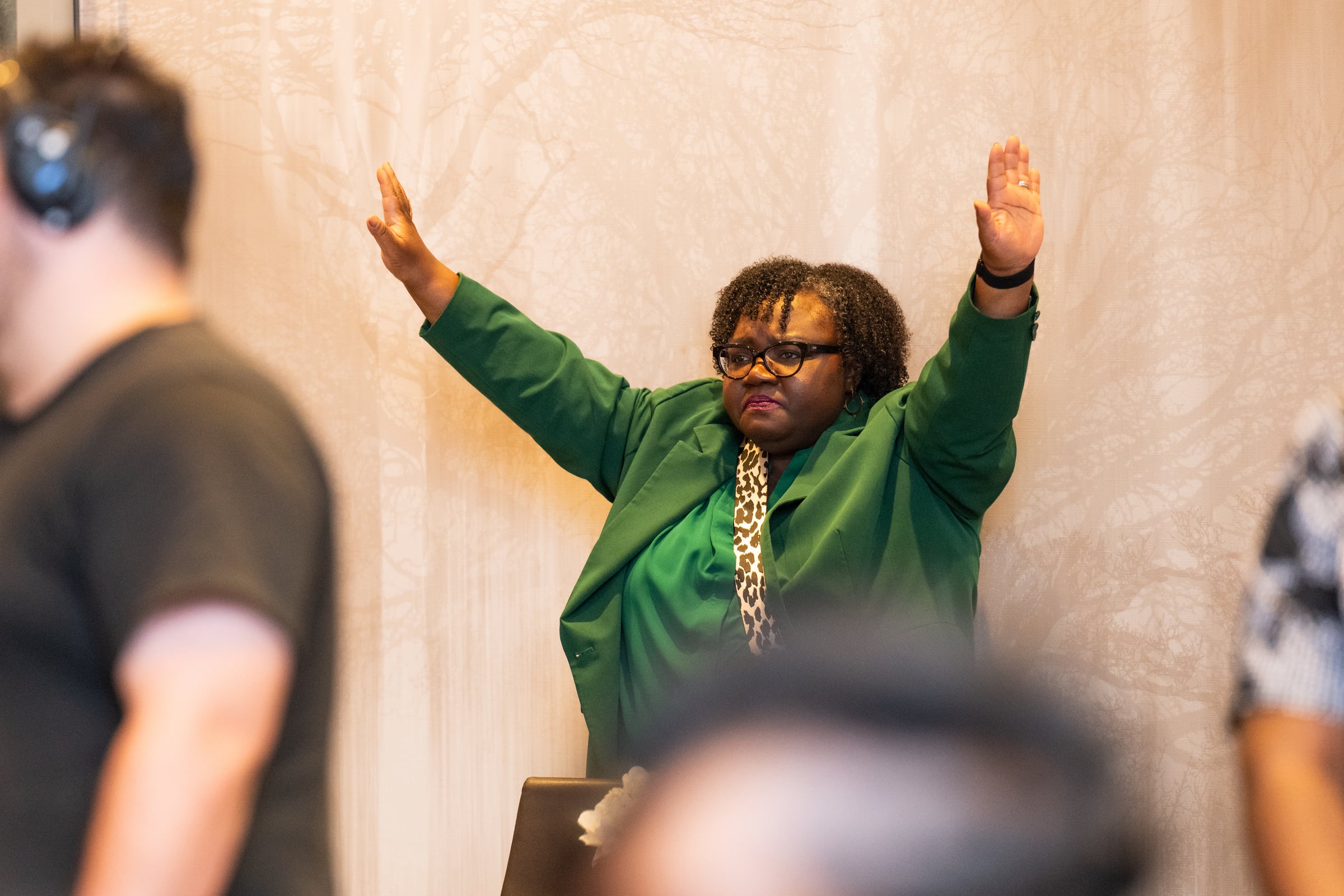 A participant raising her hands during an UNPLUG session