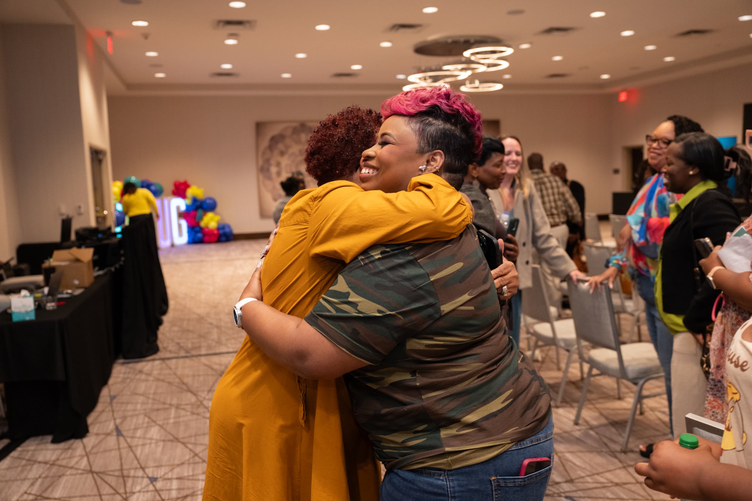 LaShawn Davis hugging a participant at UNPLUG