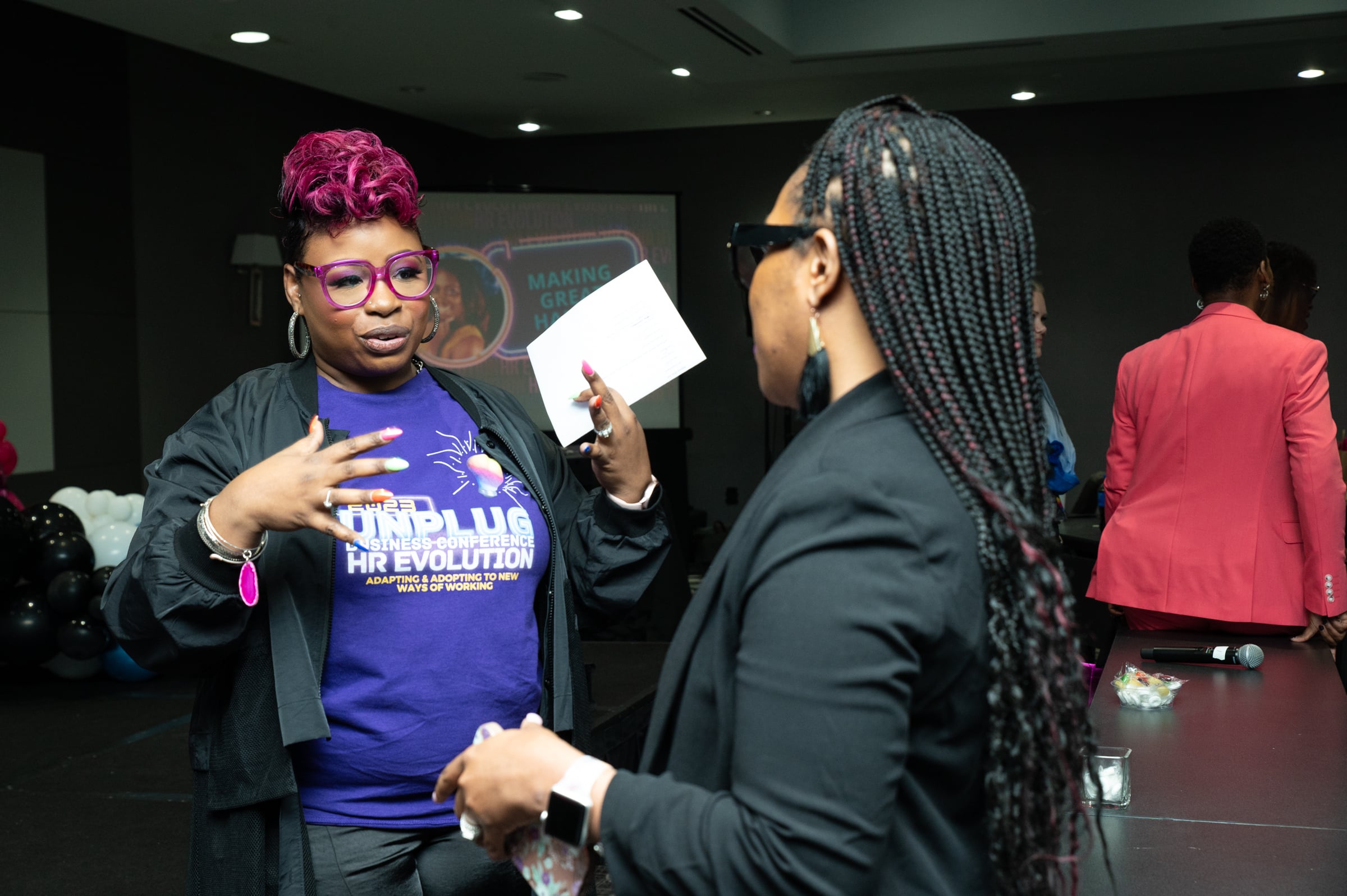 LaShawn Davis talking with a participant at UNPLUG